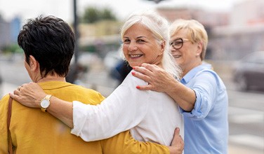 Group of women smiling while walking together outside