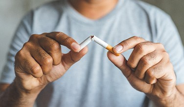 Closeup of patient breaking cigarette