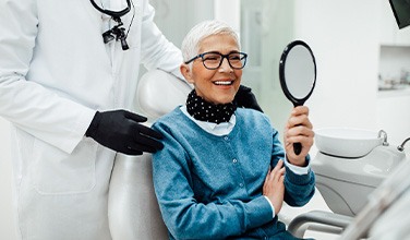 Senior woman smiling while looking at reflection