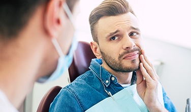 Patient with toothache looking at dentist