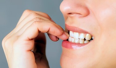 Closeup of patient biting their nails