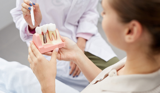 Riverdale Park patient learning how dental implants work 