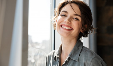 Smiling Riverdale Park patient with new dental implants
